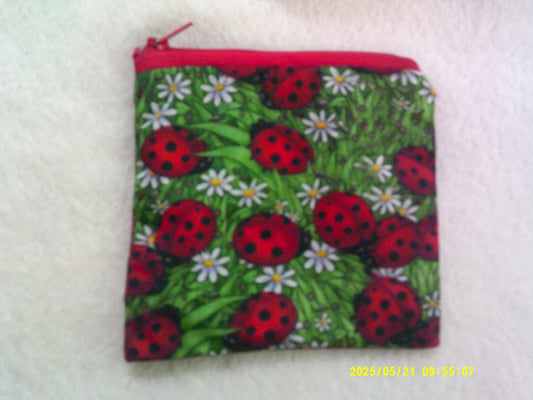 Coin purse , Ladybirds on grass